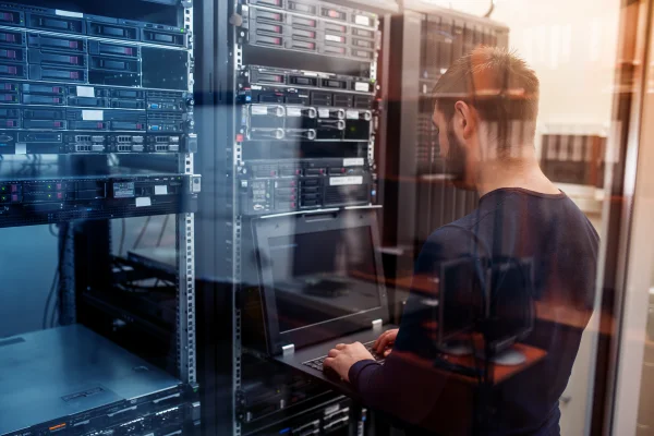 Engineer in data centre looking at rack space